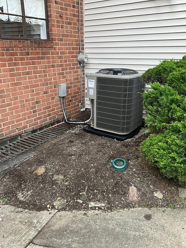 Completed full HVAC system replacement including furnace, evaporator coil, and air conditioning condenser unit. Installed new outdoor condensing unit on pad against exterior wall with proper electrical disconnect and refrigerant line connections. Indoor installation includes new furnace with plenum assembly and Honeywell electronic air cleaner for enhanced air filtration. System tested and verified operational with temperature readings confirming proper performance at 73.5°F. All components properly connected with appropriate ductwork transitions and electrical connections to code.