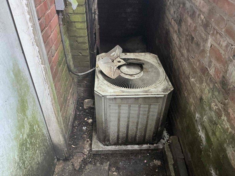 Assessed 25-year-old commercial air conditioning system with failed condenser fan motor located in exterior service alley. Unit showed extensive age-related deterioration, surface contamination, and complete fan assembly failure rendering system inoperable. Provided comprehensive replacement estimate for new commercial HVAC system scheduled for installation, including removal of existing equipment, proper disposal, and installation of appropriately-sized replacement unit to restore cooling capacity to facility.