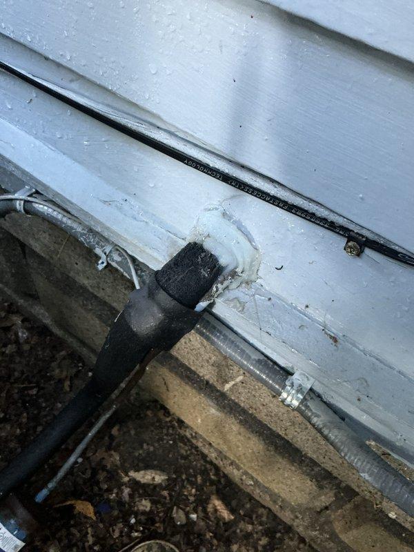 Performed comprehensive tune-up on 15-year-old air conditioning system operating normally at time of service. Inspected outdoor condensing unit, refrigerant lines, and electrical components per standard maintenance protocol. Addressed customer concern regarding gap in foam line insulation on exterior refrigerant lines by inspecting insulation condition and verifying proper coverage. Cleared accumulated debris including leaves and organic matter from around outdoor unit base and foundation area to ensure proper airflow and drainage. Verified all mechanical connections secure and system operating within manufacturer specifications.