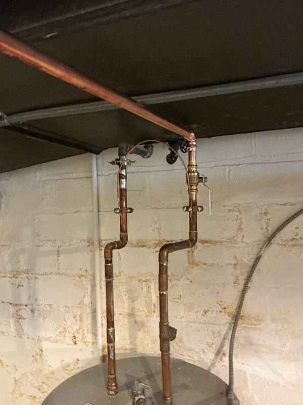 Replaced deteriorated galvanized cold water supply line from manifold to laundry sink with new PEX A tubing routed along basement ductwork. Transitioned from PEX to copper piping at laundry room ceiling to maintain proper electrical grounding continuity for the plumbing system.