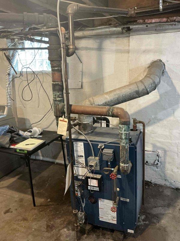 Conducted comprehensive assessment of 5-year-old boiler system that was improperly installed, documenting extensive installation deficiencies including corroded copper piping with severe verdigris oxidation and improper pipe routing. Prepared detailed replacement estimate addressing code violations, deteriorated components, and necessary corrections to bring system up to manufacturer specifications and industry standards.
