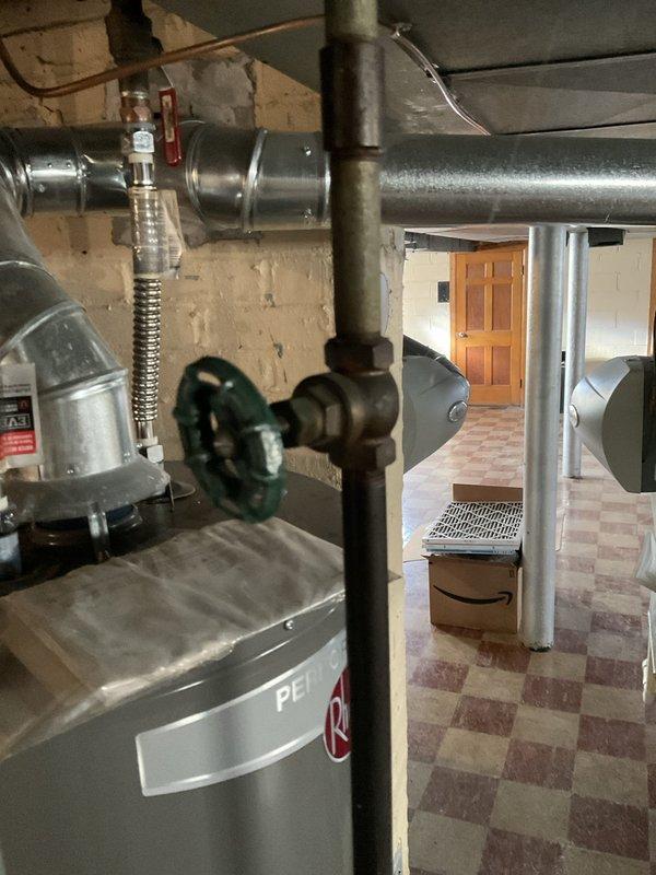 Performed routine maintenance on tanked water heater in basement mechanical room. Inspected all plumbing connections, valves, and pipe assemblies for proper operation and signs of wear. Verified valve functionality and checked mounting hardware for secure installation. System found to be operating within normal parameters with all components functioning as designed.
