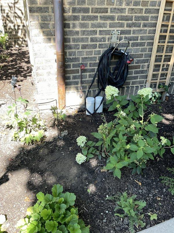 Responded to service call for leaking outdoor faucet that was previously installed by our company. Upon inspection, identified leak at gate valve connection on ground-level spigot with red wheel handle. Repaired valve assembly, tested for proper operation and confirmed leak was eliminated, restoring full functionality to the outdoor water source.