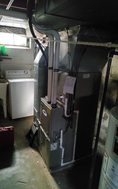 Completed comprehensive tune-up and safety inspection on 12-year-old gas furnace in basement mechanical room. Performed combustion analysis using digital analyzer, verifying oxygen levels, carbon monoxide, carbon dioxide, and temperature differentials all within manufacturer specifications at 91.5°F. All system components inspected, unit operating efficiently with proper airflow through ductwork and no safety concerns identified.