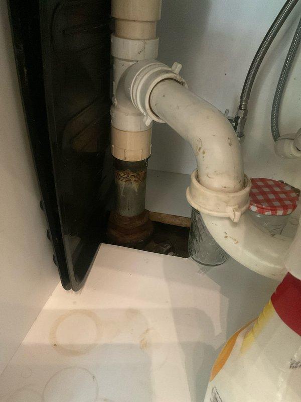 Responded to kitchen sink drainage issue with water backing up into dishwasher. Upon inspection, identified clog in drain line connected to Badger 5+ garbage disposal unit. Cleared obstruction from drain system, verified proper water flow through disposal and dishwasher connection, and tested all plumbing connections under sink to ensure no leaks. System restored to normal operation with proper drainage confirmed.