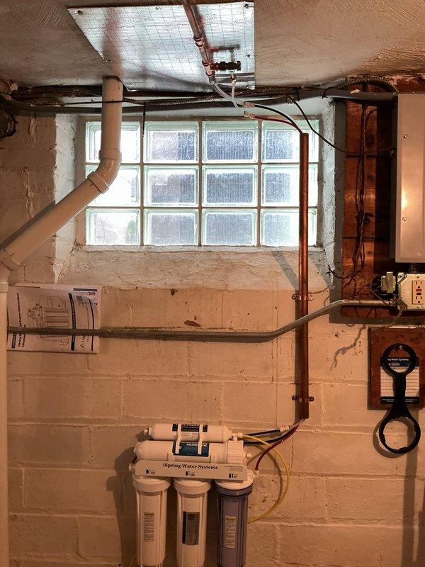 Installed iSpring reverse osmosis water filtration system on basement block wall, including three-stage filter housings, pressurized storage tank, and all necessary supply lines and connections. Additionally, installed a comfort height elongated toilet with seat and angle stop valve on the second floor. First year of replacement filters provided with the system installation.