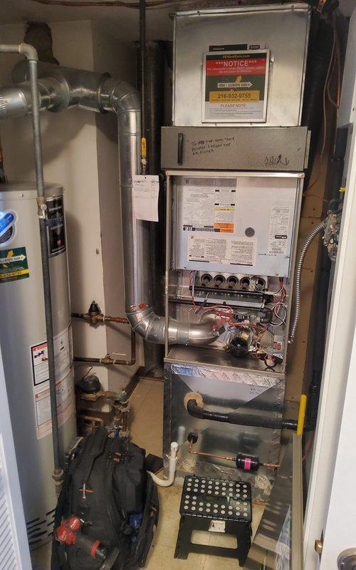 Completed annual maintenance and tune-up on a 4-year-old residential gas furnace located in basement utility closet. Performed comprehensive system inspection including burner operation verification, blower motor assessment, heat exchanger examination, and electrical connection testing. All components found operating within normal parameters with blue burner flames indicating proper combustion, ECM inducer blower functioning correctly, and control board displaying normal status readings.