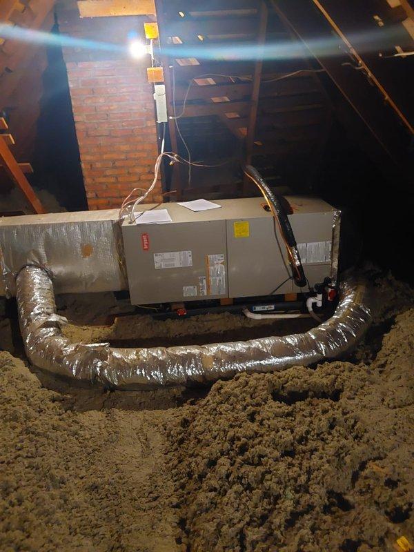 Completed full HVAC system replacement, removing existing equipment and installing new heat pump system with outdoor condensing unit and indoor air handler. The outdoor heat pump was positioned on composite pad with proper clearances against brick exterior, with refrigerant lines routed along exterior wall to attic penetration. In the attic space, installed new air handler on insulated platform with connections to existing ductwork system, ran condensate drain line via PVC piping, completed refrigerant line connections with proper insulation, and integrated Ecobee smart thermostat for system control. All electrical connections were made to code, system was pressure tested, evacuated, and charged to manufacturer specifications. Verified proper airflow through all zones and confirmed heating and cooling operation across all system modes.