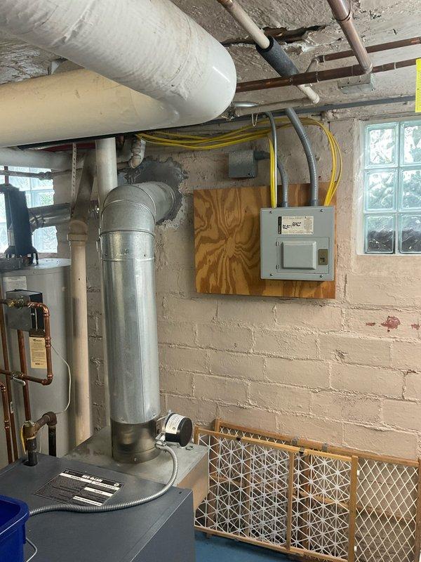 Completed on-site evaluation for tankless water heater installation in residential basement utility space. Assessed existing plumbing infrastructure, including aged copper piping and valve assembly showing significant corrosion, documented current venting configuration with vertical exhaust stack, and evaluated electrical panel capacity and placement for new unit requirements. Provided comprehensive estimate for tankless water heater replacement, including necessary modifications to gas lines, water supply connections, venting system upgrades, and electrical work to accommodate new high-efficiency unit.