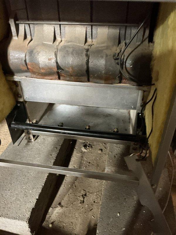 # HVAC Service - Tune-up

Performed annual maintenance on a 21-year-old Lennox boiler system. Upon arrival, discovered the gas supply had been shut off by another contractor during a previous dryer installation and was not restored. Completed full boiler tune-up inspection, including examination of the heat exchanger which showed age-appropriate surface oxidation and minor rust discoloration on the cylindrical coil assembly. Inspected condensate pan and found normal moisture accumulation with minor sediment buildup. Verified all mounting brackets and support systems were secure. After completing maintenance procedures, restored gas supply to the unit and verified proper operation of all system components.