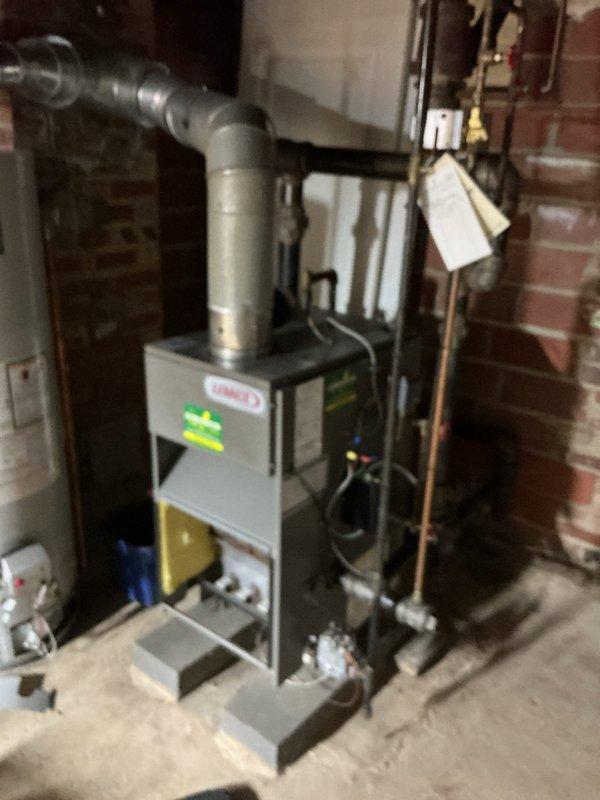 # HVAC Service - Tune-up

Performed annual maintenance on a 21-year-old Lennox boiler system. Upon arrival, discovered the gas supply had been shut off by another contractor during a previous dryer installation and was not restored. Completed full boiler tune-up inspection, including examination of the heat exchanger which showed age-appropriate surface oxidation and minor rust discoloration on the cylindrical coil assembly. Inspected condensate pan and found normal moisture accumulation with minor sediment buildup. Verified all mounting brackets and support systems were secure. After completing maintenance procedures, restored gas supply to the unit and verified proper operation of all system components.