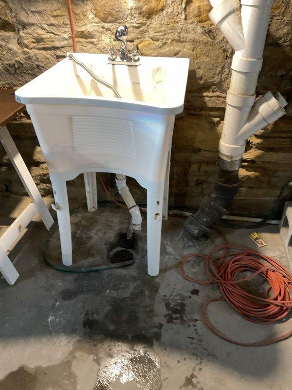 Reconnected basement utility sink to existing plumbing infrastructure, restoring full functionality to the wash basin. All supply lines and drainage connections were properly secured and tested for leaks, with the installation verified to be operating correctly.