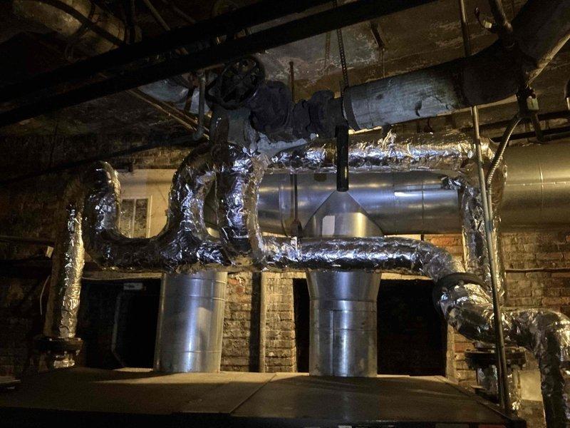 Conducted on-site evaluation for commercial steam boiler replacement in industrial mechanical room. Assessed existing 2 million BTU steam boiler system, documented current equipment configuration including extensive ductwork network, insulated piping, and associated mechanical components for preparation of replacement estimate.