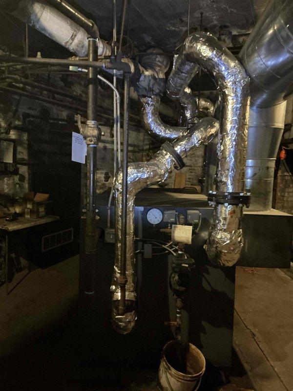 Conducted on-site evaluation for commercial steam boiler replacement in industrial mechanical room. Assessed existing 2 million BTU steam boiler system, documented current equipment configuration including extensive ductwork network, insulated piping, and associated mechanical components for preparation of replacement estimate.