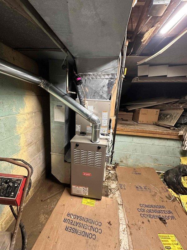 Completed full HVAC system replacement including removal of existing equipment and installation of new Bryant furnace, evaporator coil, and outdoor condensing unit. Installed new furnace in basement mechanical room with proper venting through existing exhaust duct penetration. Mounted evaporator coil on top of furnace plenum and connected refrigerant lines to outdoor condenser. Verified all electrical connections to furnace control board and condensing unit per manufacturer specifications. Performed system startup procedures and confirmed proper airflow by measuring static pressure at 150 pascals using digital manometer. Tested heating and cooling cycles to ensure equipment operates within normal parameters. Customer was informed that existing thermostat may not be compatible with new system but will attempt programming if possible.