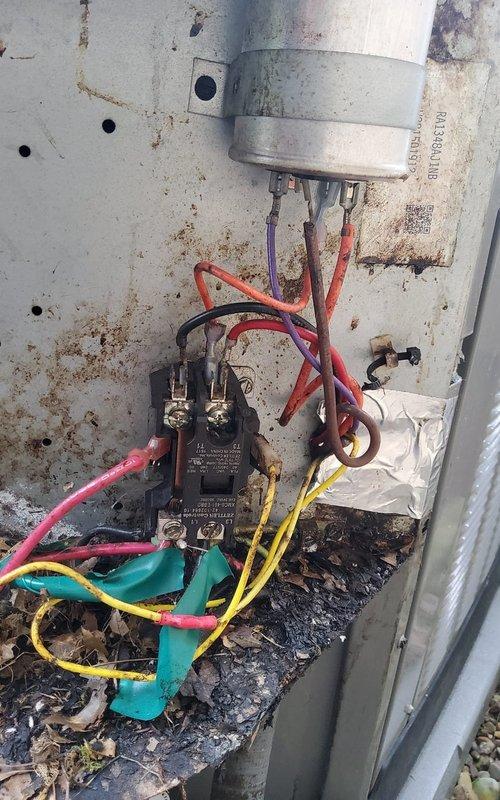 Performed comprehensive pre-winter inspection on 12-year-old residential furnace system. Upon arrival, conducted visual assessment of unit with access panel removed to examine internal components. Inspected burner assembly, heat exchanger, blower motor, and all electrical connections. Noted operational components including gas burner rack with blue flame operation, blower assembly with motor housing, and PVC venting system with proper directional flow indicators.

Examined electrical system including capacitor, contactor, and associated wiring connections. Observed evidence of significant deterioration on outdoor electrical components, including rust staining, corrosion on metal panels, and charred debris accumulation indicating previous electrical arcing or burning at contactor assembly. Documented condition of all colored wire connections (red, purple, yellow, orange, blue, green, and pink) throughout control system.

Verified all safety labels and specification plates remained legib
