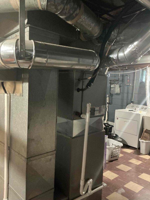 Conducted furnace and air conditioning replacement estimate for residential HVAC system over 16 years old. Evaluated existing Carrier equipment and ductwork configuration in basement utility area, documented current system condition through photographs, and discussed available replacement options including current promotional offerings with homeowner.