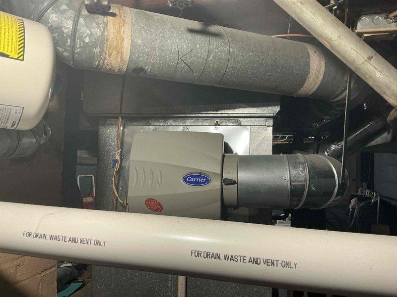 Conducted furnace and air conditioning replacement estimate for residential HVAC system over 16 years old. Evaluated existing Carrier equipment and ductwork configuration in basement utility area, documented current system condition through photographs, and discussed available replacement options including current promotional offerings with homeowner.