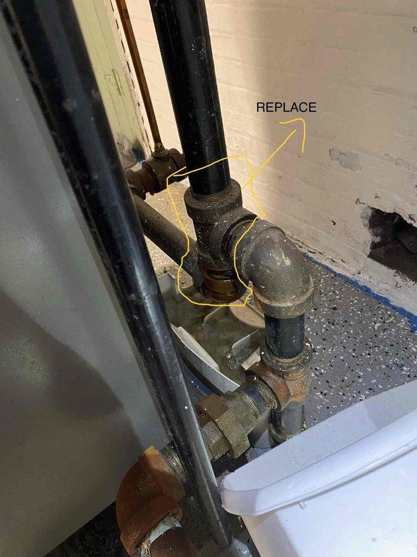 Responded to emergency service call for boiler overflow and complete loss of water supply to residence. Upon arrival, investigated 20-25 year old boiler system in basement and confirmed that automatic fill valve was left in open position, causing extensive water overflow throughout the area. Inspected plumbing connections and identified severely corroded and deteriorated pipe fittings at the water supply line that required immediate replacement. Documented extensive water damage to basement floor and walls, including moisture infiltration and degraded surfaces. Traced water supply issue and determined that main water supply had been shut off, likely as emergency response to the overflow condition. Marked failed components for replacement and provided assessment of aged plumbing infrastructure showing significant corrosion and end-of-service-life deterioration. Photographed conditions for documentation purposes.