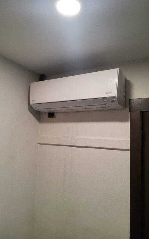 Responded to service call for five-year-old wall-mounted mini split unit experiencing water leakage with blue staining visible beneath the unit. Upon arrival, accessed the third-floor location and performed visual inspection of the indoor air handler. Opened the front cover to expose internal components including the filter assembly, evaporator coil, and drain system. Inspected the mesh filter panel, evaporator coil section, and internal drainage pathways for blockages or abnormalities. Documented unit condition and visible staining on wall surface below the unit with photographic evidence for service records.