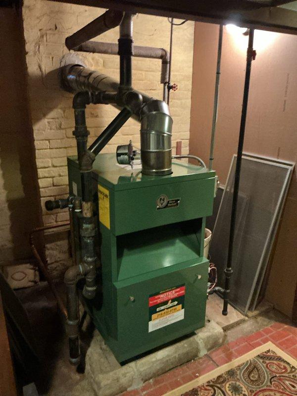 Performed routine maintenance service on a 2-year-old residential boiler system located in basement mechanical room. Conducted comprehensive inspection of boiler unit, control systems, and associated components. Verified proper operation of electrical controls, inspected pressure gauge readings, examined copper piping connections for leaks or corrosion, and checked all safety systems. All components found to be functioning within normal parameters with no issues identified requiring repair.