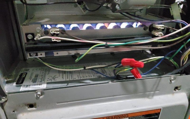 Responded to service call for furnace control panel evaluation. Upon arrival, performed diagnostic inspection of gas furnace system in basement utility area. Verified burner assembly operation with all igniters firing properly and producing proper blue flame pattern. Inspected electrical control wiring including ignition system connections, safety circuits, and thermostat wiring. Documented current system condition with photographs showing burner operation and overall unit configuration. Examined control board and associated electrical components for signs of failure or malfunction. Assessed control panel replacement requirements and prepared quotation for new control board installation. Unit operational at time of departure pending customer approval for control panel replacement.