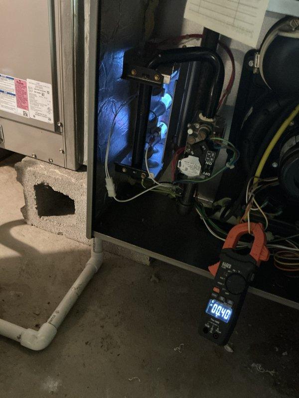 Completed comprehensive tune-up service on both gas furnace (5 years old) and steam boiler (10 years old) located in basement. Performed electrical diagnostics using clamp meter to verify proper amperage draw and capacitor function on furnace system, inspected burner operation with visible flame verification, and evaluated all mechanical components. Addressed insulation displacement around equipment and confirmed both units operating within manufacturer specifications.