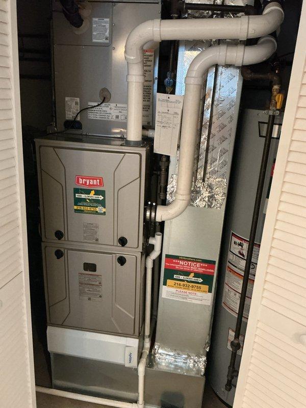Responded to service call for Bryant furnace experiencing intermittent blower motor operation and overheating thermostat. Upon arrival, found unit had been placed in safety mode due to blower motor activating independently after system had been powered down for over a week. Inspected electrical connections at furnace control board and thermostat wiring for potential short circuits or control failures. Documented existing installation configuration including PVC venting system and overall equipment setup. Advised on safety concerns related to thermostat temperature and independent blower operation, indicating possible control board malfunction or wiring issue requiring further diagnostic testing and component replacement.