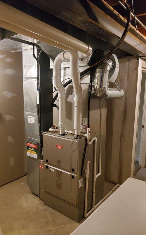 Completed comprehensive heating maintenance on a 5-6 year old Bryant electric furnace system. Performed full system inspection including burner assembly operation verification, confirmed proper ignition sequence with burners firing cleanly with blue flames, checked all electrical connections and safety controls, inspected heat exchanger, verified proper venting through PVC intake and exhaust pipes, and tested blower motor operation. All components found operating within normal parameters and system returned to service in good working condition.