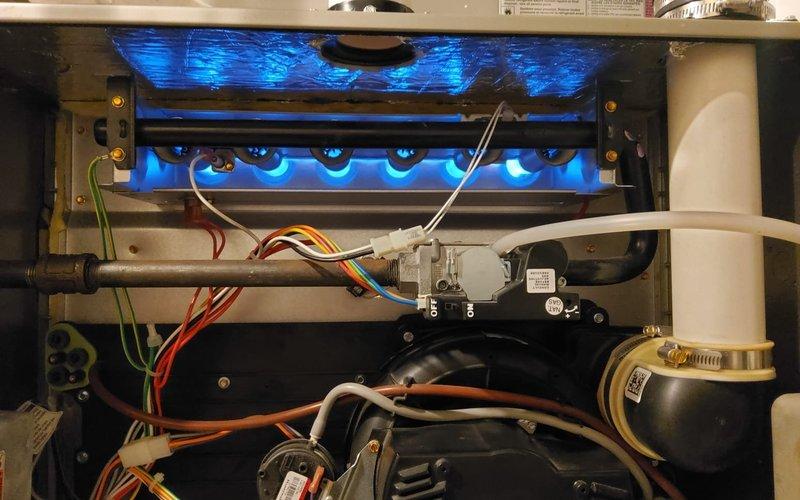 Completed comprehensive heating maintenance on a 5-6 year old Bryant electric furnace system. Performed full system inspection including burner assembly operation verification, confirmed proper ignition sequence with burners firing cleanly with blue flames, checked all electrical connections and safety controls, inspected heat exchanger, verified proper venting through PVC intake and exhaust pipes, and tested blower motor operation. All components found operating within normal parameters and system returned to service in good working condition.