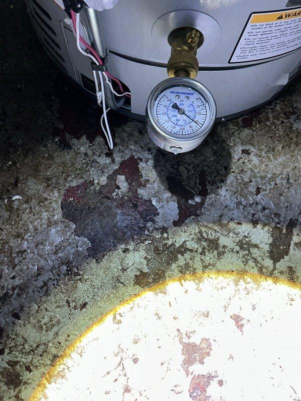 Completed service return trip to install new water heater with pressure relief valve. System tested and confirmed operational with proper pressure readings via gauge monitoring. Previous water damage and floor staining observed at installation location, indicating prior leakage issues have been resolved with new equipment installation.