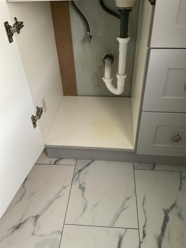 Responded to water leak complaint in downstairs half bath with ceiling damage. Upon investigation, traced leak source to upstairs closet area where carpet showed significant water staining and discoloration. Inspected bathroom vanity plumbing connections, P-trap assembly, and supply lines for potential failure points in the fifty-year-old home's plumbing system.