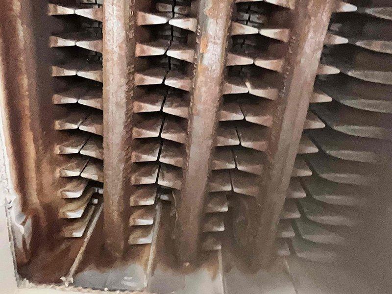Performed scheduled maintenance on a 5-year-old steam heating system. Inspected heat exchanger and found moderate rust and corrosion present on vertical tubes and fin structures, which is typical for steam systems of this age but will require monitoring during future service visits. Examined crawl space installation, verified proper mounting and support structures, and confirmed all piping and ductwork remain secure and properly positioned. System is currently operational and does not require immediate renewal at this time.