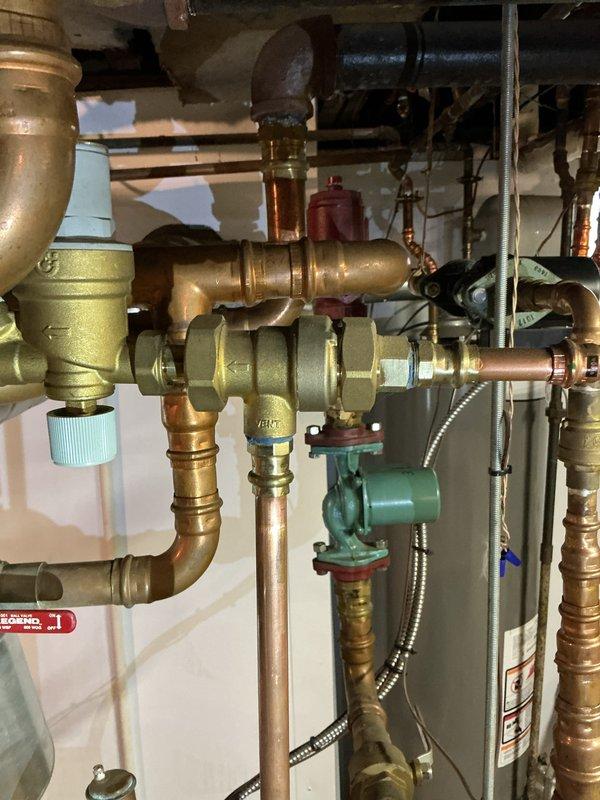 Performed comprehensive inspection on 10-year-old residential boiler system. Examined expansion tank, circulator pumps, pressure relief valves, and all associated copper piping and brass fittings for proper operation and potential wear. Verified system pressure, checked all valve operations, inspected circulator pump function, and confirmed proper connections throughout the heating distribution network. All components found to be operating within normal parameters with no immediate repairs required at this time.