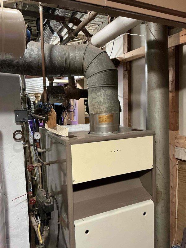 Performed comprehensive assessment of 50+ year old boiler system for replacement estimate. Customer previously advised by another contractor that unit required replacement but was not provided diagnostic information. Documented existing system configuration including aged furnace/air handler unit, associated ductwork, gas piping, water connections, and pressure control components in basement mechanical room. Photographed current equipment installation to provide accurate replacement specifications when customer is ready to proceed with system upgrade.