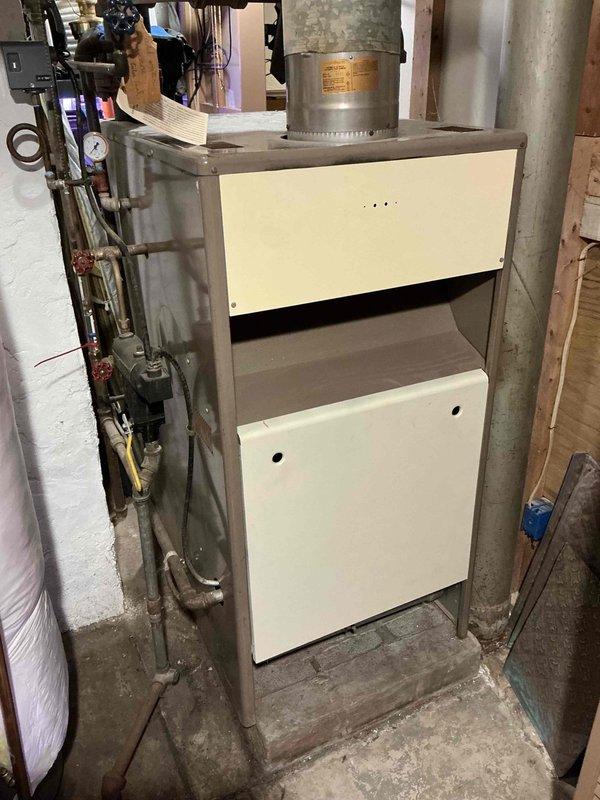 Performed comprehensive assessment of 50+ year old boiler system for replacement estimate. Customer previously advised by another contractor that unit required replacement but was not provided diagnostic information. Documented existing system configuration including aged furnace/air handler unit, associated ductwork, gas piping, water connections, and pressure control components in basement mechanical room. Photographed current equipment installation to provide accurate replacement specifications when customer is ready to proceed with system upgrade.