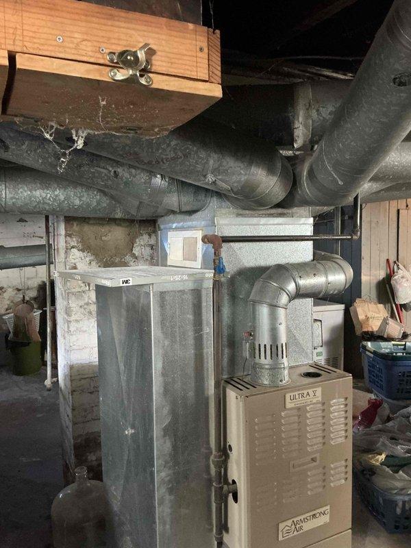 Conducted comprehensive evaluation of existing HVAC system including Armstrong Ultra V furnace unit and associated ductwork infrastructure in basement mechanical room. Documented current equipment condition, noting age-related wear on flexible ductwork with dust accumulation, and assessed overall system configuration including water heater and expansion tank setup. Provided detailed replacement estimate for complete system upgrade to address equipment lifecycle and efficiency concerns.