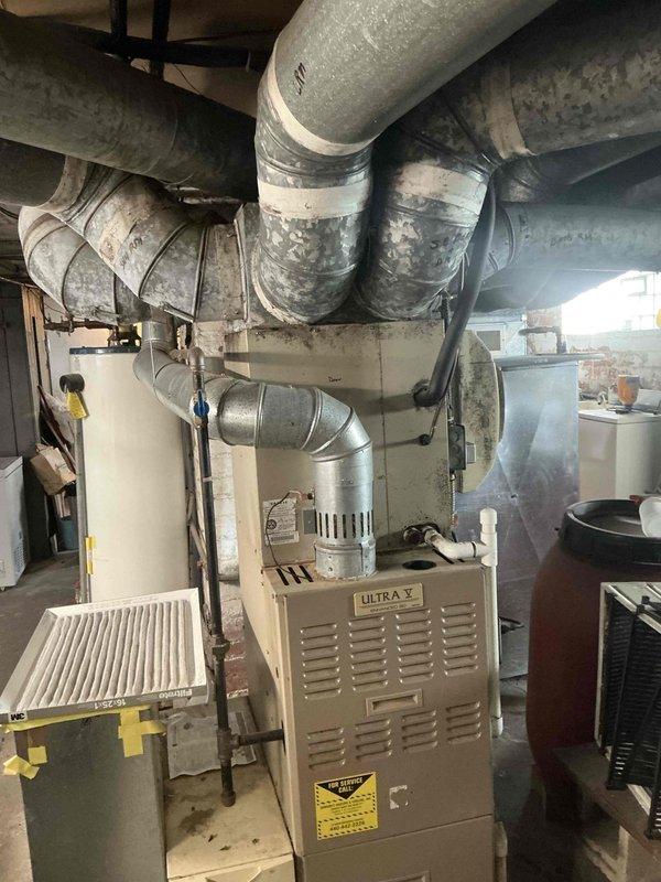 Conducted comprehensive evaluation of existing HVAC system including Armstrong Ultra V furnace unit and associated ductwork infrastructure in basement mechanical room. Documented current equipment condition, noting age-related wear on flexible ductwork with dust accumulation, and assessed overall system configuration including water heater and expansion tank setup. Provided detailed replacement estimate for complete system upgrade to address equipment lifecycle and efficiency concerns.