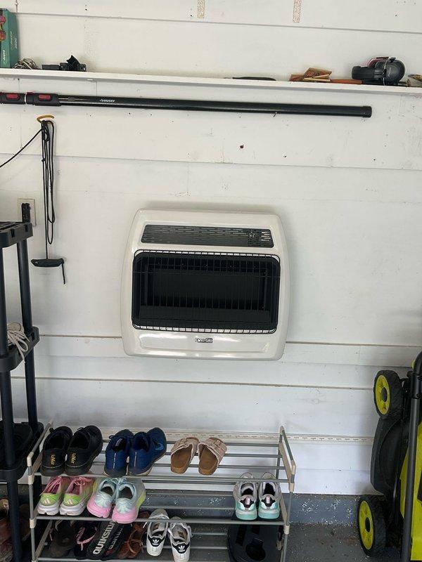 Installed and connected gas line to wall-mounted garage heater unit. Ran black iron pipe from existing gas supply, secured all connections with proper fittings, and pressure tested system to ensure leak-free operation. Heater is now fully operational and ready for use.