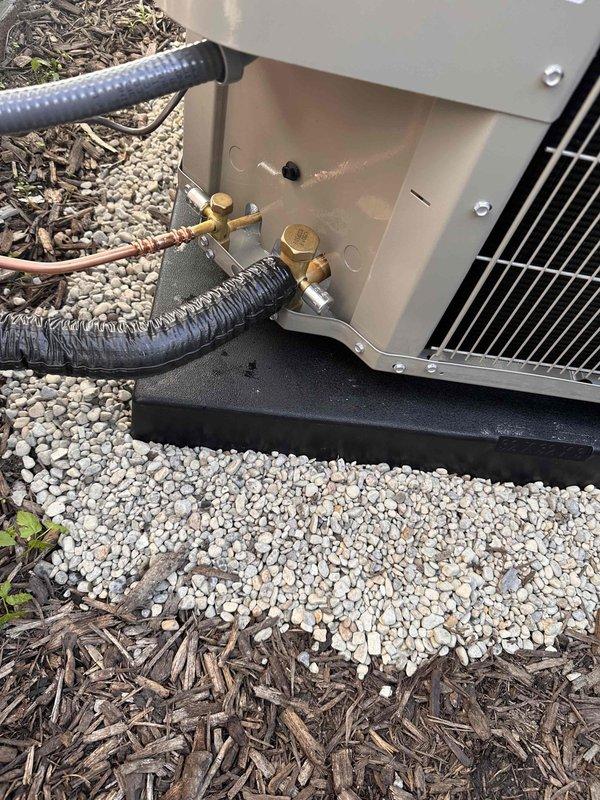 Completed full Unico high velocity AC system installation including smart high-efficiency blower module, coated evaporator coil module for extended longevity, and new Bryant outdoor condensing unit. Installed new condenser pad with gravel base, electrical disconnect box mounted to exterior wall, and drain pan equipped with safety switch. Reused existing thermostat and added three additional supply outlets to optimize airflow distribution throughout the system. Replaced and enlarged the first two feet of supply ductwork per Unico specifications to ensure proper system performance. All refrigerant lines connected with brass fittings and properly insulated, unit secured on composite pad with appropriate clearances from structure. System tested and operational.