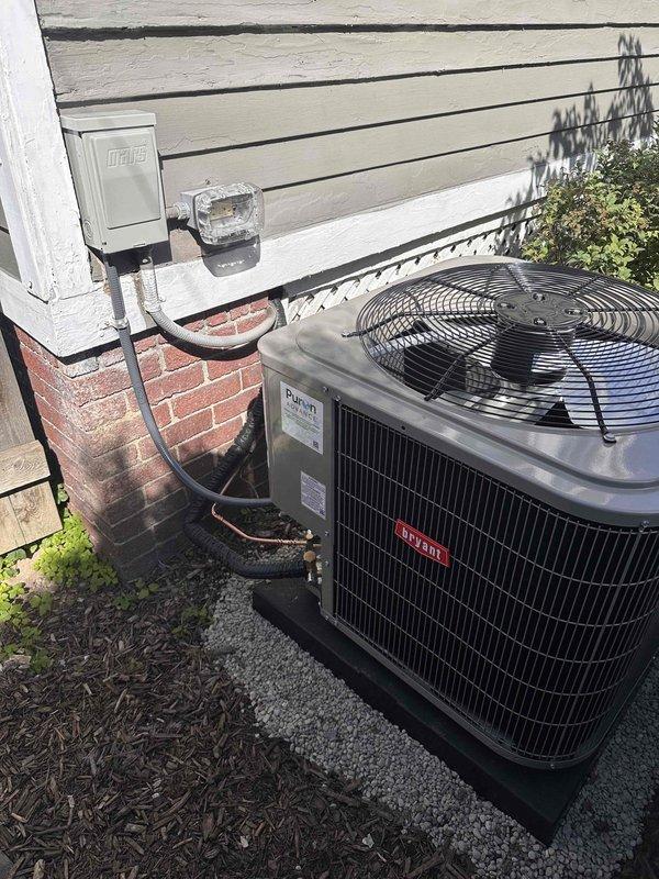 Completed full Unico high velocity AC system installation including smart high-efficiency blower module, coated evaporator coil module for extended longevity, and new Bryant outdoor condensing unit. Installed new condenser pad with gravel base, electrical disconnect box mounted to exterior wall, and drain pan equipped with safety switch. Reused existing thermostat and added three additional supply outlets to optimize airflow distribution throughout the system. Replaced and enlarged the first two feet of supply ductwork per Unico specifications to ensure proper system performance. All refrigerant lines connected with brass fittings and properly insulated, unit secured on composite pad with appropriate clearances from structure. System tested and operational.