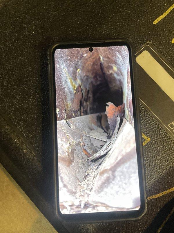 Completed standard tune-up maintenance on a 30-year-old furnace system. Upon inspection, discovered significant deterioration and rust damage to the heat exchanger, with visible cavities and corrosion present. Documented the compromised condition with photos showing extensive weathering, discoloration, and structural degradation that poses potential safety concerns for continued operation.