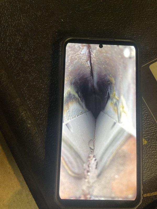 Completed standard tune-up maintenance on a 30-year-old furnace system. Upon inspection, discovered significant deterioration and rust damage to the heat exchanger, with visible cavities and corrosion present. Documented the compromised condition with photos showing extensive weathering, discoloration, and structural degradation that poses potential safety concerns for continued operation.