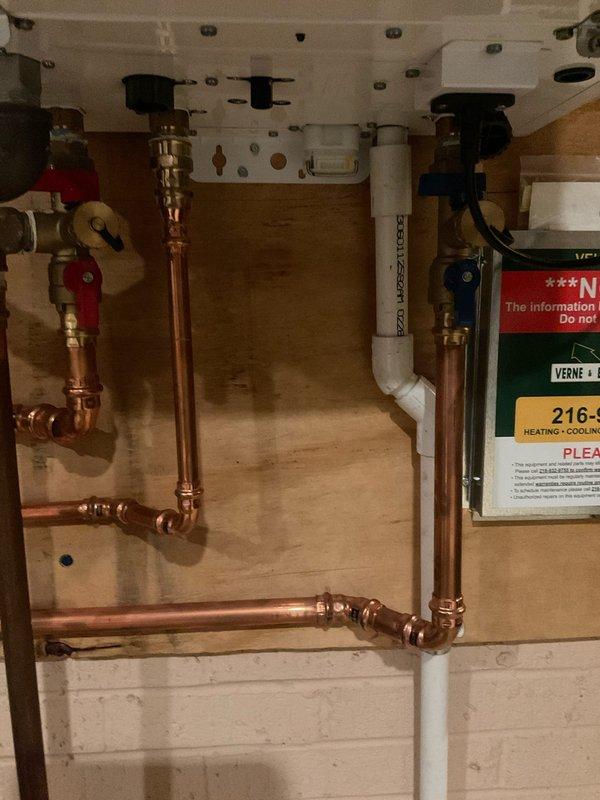 Performed routine maintenance flush on Navien NPE-240A2 tankless water heater to remove mineral buildup and maintain optimal performance. Completed descaling procedure using appropriate flushing solution, circulated through heat exchanger, and refilled system. Verified all plumbing connections, shut-off valves, and drain lines under sink cabinet were secure and operating properly upon completion.