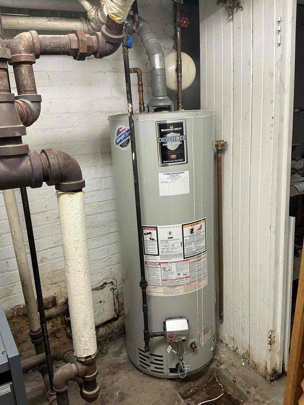 Conducted on-site evaluation of residential steam boiler system for replacement estimate. Assessed existing 30+ year old Weil-McLain boiler unit, associated piping infrastructure including supply and return lines, and water heater configuration in basement mechanical room. Documented equipment condition, photographed current installation showing aged piping with visible corrosion on metal fittings, and reviewed system layout to provide comprehensive replacement recommendations with financing options.