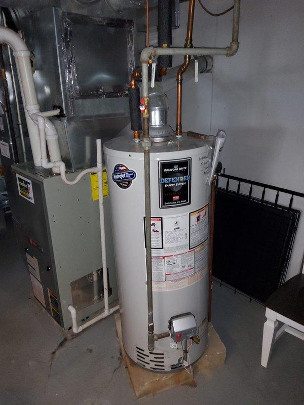 Performed complete flush of tanked water heater equipped with Defender Safety System to remove sediment buildup and maintain optimal heating efficiency. Conducted comprehensive plumbing inspection of the residential system, including examination of copper supply lines, brass fittings, PVC drainage connections, cast iron waste stack, and galvanized horizontal piping throughout the basement mechanical room and exposed joist areas, with all components found to be functioning properly and installation documented photographically.
