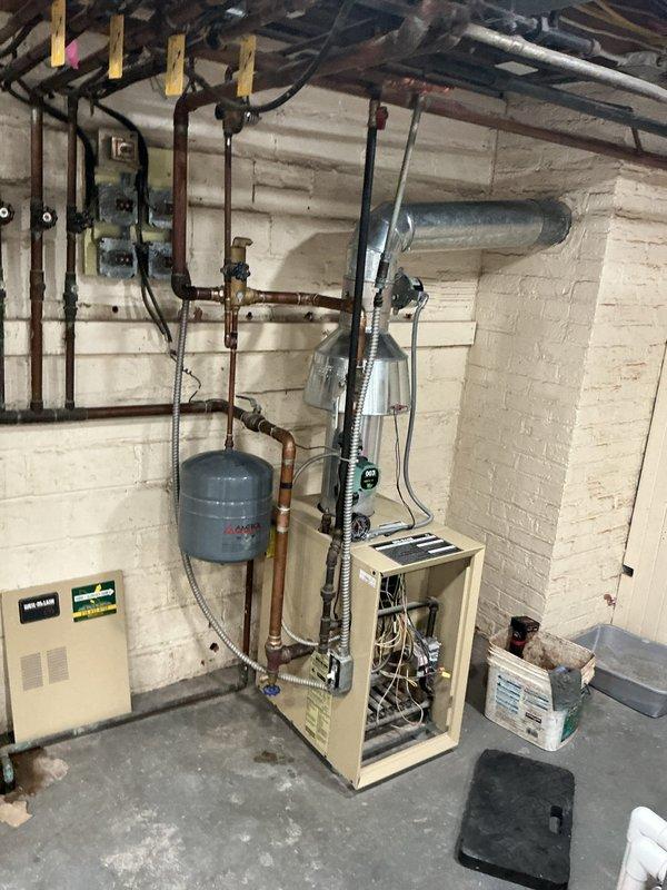 Completed preventive maintenance on two boiler systems: one steam boiler and one hot water boiler. Performed combustion analysis with readings showing CO2 at 6.0% and flue temperature at 318.9°F, indicating proper combustion efficiency. Inspected all mechanical components, piping systems, expansion tank, valves, safety controls, and electrical connections on both units to ensure optimal operation for the heating season.
