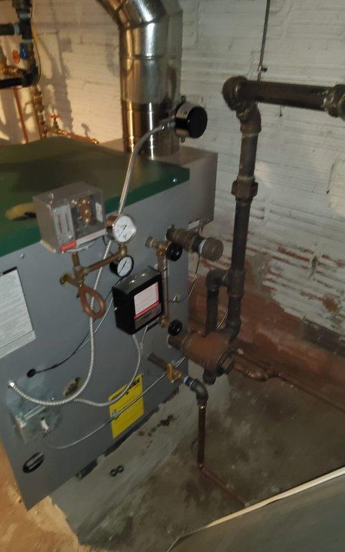 Completed preventive maintenance on gas-fired heating system. Inspected heat exchanger fins for proper condition and airflow, verified all mechanical components including circulator pump and pressure gauges were operating within normal parameters. Confirmed boiler unit, piping connections, and ductwork were secure with no visible leaks or safety concerns.