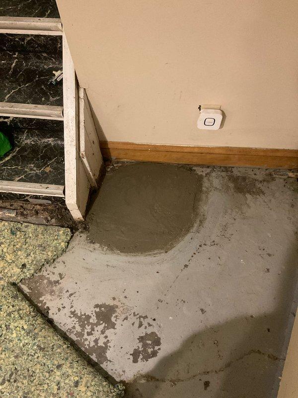 Replaced deteriorated clay wye section where first floor stack connects to basement floor drain due to moisture damage and structural failure. Broke open concrete floor, removed compromised clay piping, and installed new PVC section with proper connections. Bedded replacement pipe in gravel for stability and drainage, then repoured and finished concrete floor to restore surface integrity.