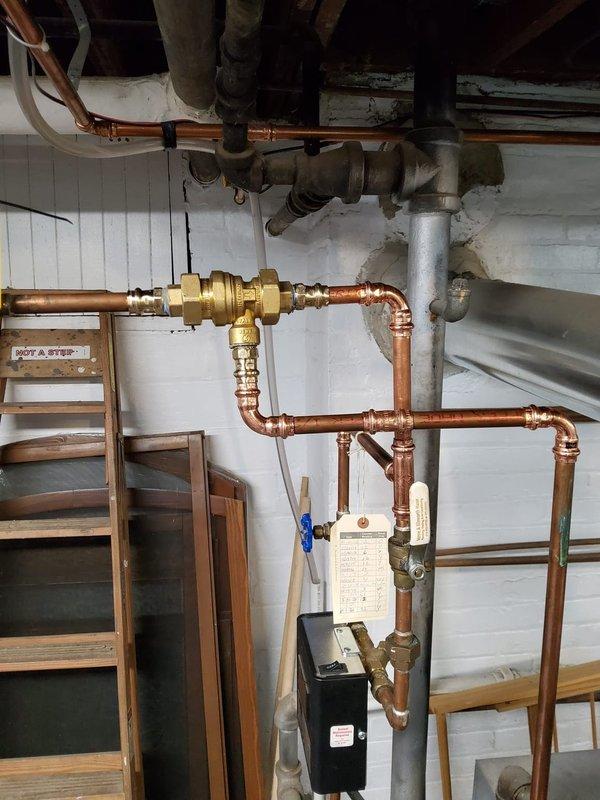 # HVAC Maintenance - Heating System Service

Completed comprehensive annual heating maintenance on a 13-year-old MVP boiler system as part of recurring Home Plan service. Performed full system inspection including burner assembly examination, where all five burner tubes were assessed for proper operation and flame characteristics. Noted normal operational wear with surface oxidation present on burner components consistent with system age.

Inspected gas manifold, ignition system components, and flame sensor wiring for proper connections and functionality. Evaluated copper piping network and hydronic distribution system, including brass valve assemblies and zone controls. Verified proper operation of zone valves and confirmed all mechanical connections were secure without leaks.

Checked control unit mounted to piping system for proper programming and operation. Tested safety controls and limit switches to ensure system shutdown protocols function correctly. Verified adequate combustion